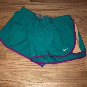 NIKE turqouise running shorts with peach sides